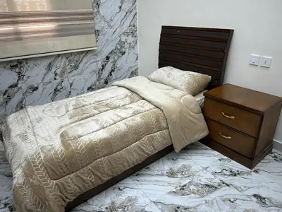 a bedroom with a bed with a nightstand and a bed sidx sidx sidx sidx at الكرك الثنية in Kerak