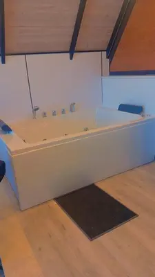 a large white bath tub in a room at منتجع وأكواخ غصن in Al Jafr