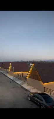 a car parked in a parking lot next to a building at The Branch Lodges in Ajloun