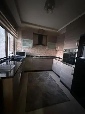 a kitchen with a sink and a stove at MK7 - Two Bedroom Apartment in Amman