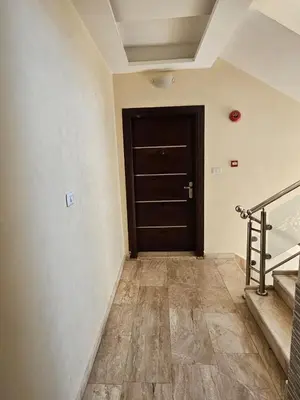 a hallway with a black door and a staircase at MK7 - Two Bedroom Apartment in Amman