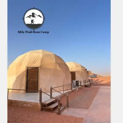 a row of tents in the middle of the desert at Mila Wadi Rum Camp in Wadi Rum
