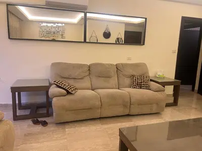 a living room with a couch and a table at Khalda apartment in Amman