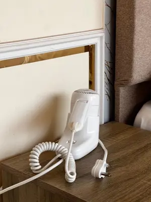 a hair dryer sitting on a table next to a mirror at Golden Stars Luxury Camp Wadi Rum in Wadi Rum