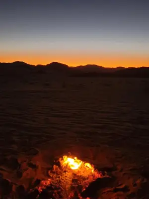 an image of a bonfire in the desert at sunset at Wadi rum Breeze of calm in Wadi Rum