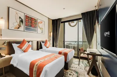 a hotel room with two beds and a flat screen tv at April Hotel in Aqaba