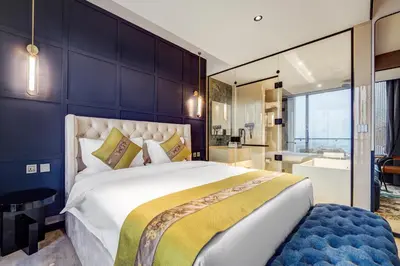 a bedroom with a large bed and a bathroom at April Hotel in Aqaba