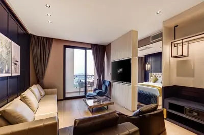 a living room with a couch and a bed at April Hotel in Aqaba