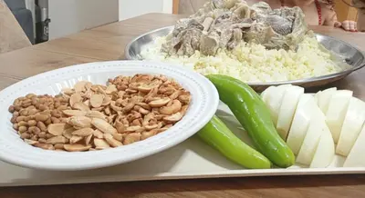 a plate of food with nuts and cheese and vegetables at Lozi House Cozy Stay in Al Azraq ash Shamālī