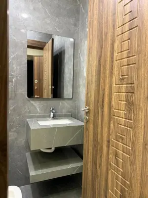 a bathroom with a sink and a mirror at Luxury apartment شقة فخمة in Amman
