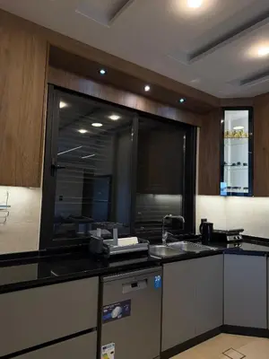 a kitchen with a sink and a large window at Luxury apartment شقة فخمة in Amman