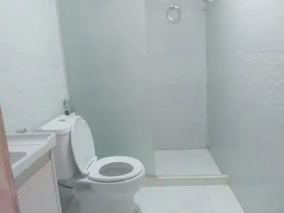 a white bathroom with a toilet and a shower at Wadi Rum Adventure Camp & Tour in Wadi Rum
