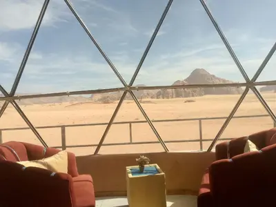 a room with a view of the desert and mountains at Wadi Rum Adventure Camp & Tour in Wadi Rum
