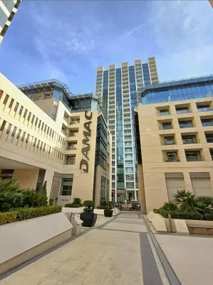 a group of tall buildings in a city at Pasha Holiday - DAMAC Tower in Amman