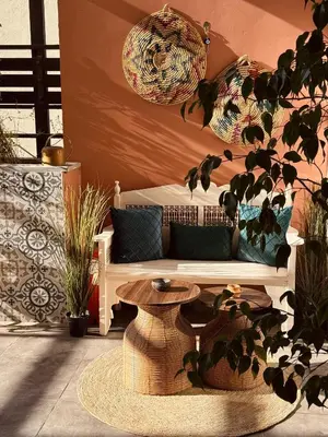 a white couch sitting in a room with plants at Weibdeh Oasis 2 Bedroom in Amman