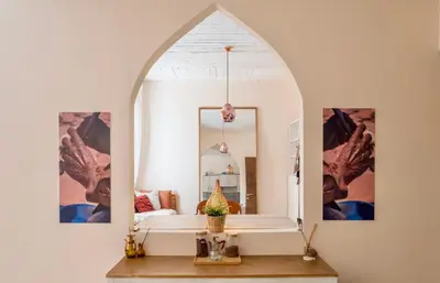 an archway in a room with a table and a mirror at Weibdeh Oasis 2 Bedroom in Amman