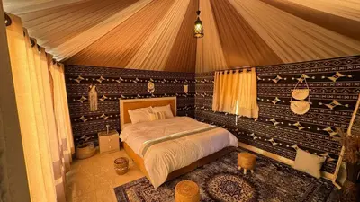 a bedroom with a bed in a tent at Wadi rum camp Ausama in Wadi Rum