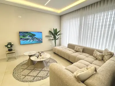 a living room with a couch and a table at شقة فندقية فاخرة في عمان قرب طريق المطار Luxury Living Near Airport Road in Amman