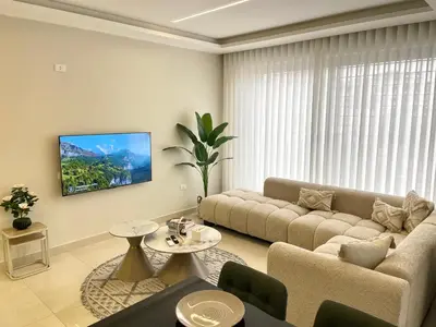 a living room with a couch and a table at شقة فندقية فاخرة في عمان قرب طريق المطار Luxury Living Near Airport Road in Amman