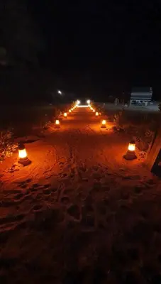 a row of lights on a road at night at Hillawi Desert Camp Wadi Rum in Disah