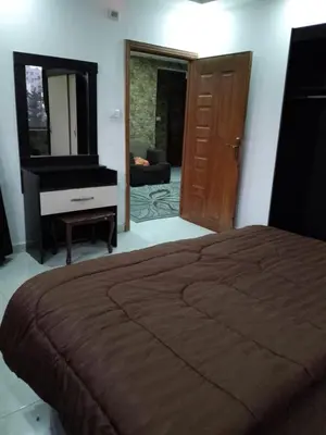 a bedroom with a bed and a mirror and a piano at شقق تلاع العلي in Amman
