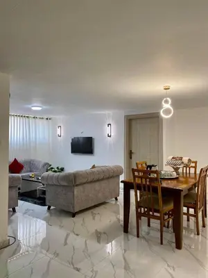 a living room with a couch and a table at W3 property in Kerak