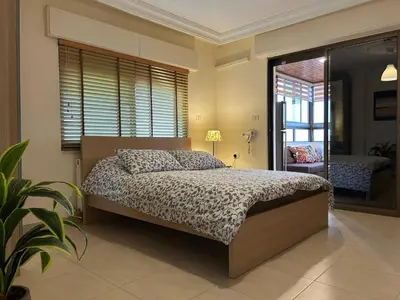 a bedroom with a bed and a large window at 7th Circle 1 bedroom flat Amman, pleasant views in Amman