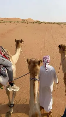 a man riding a camel in the desert at Camel Riding in Wadi Rum in Disah
