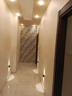a hallway with a wall with lights on it at غرفه مفروشه ومكيفه بجانب الكارفور اربد in Irbid