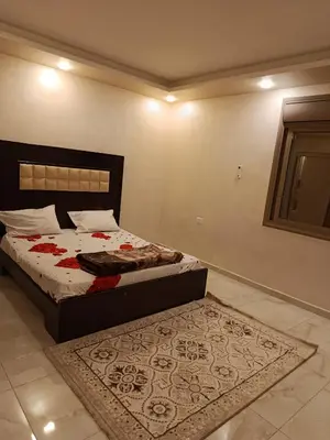 a bedroom with a bed and a rug on the floor at غرفه مفروشه ومكيفه بجانب الكارفور اربد in Irbid