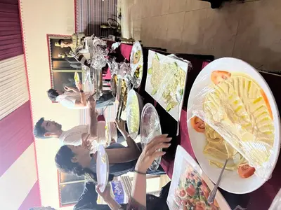 a group of girls holding plates of food at A luxurious experience under the stars of Wadi Rum in Wadi Rum