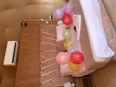 a group of balloons on the side of a bed at A luxurious experience under the stars of Wadi Rum in Wadi Rum