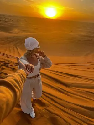 a woman walking in the desert at sunset at Wadi rum magic Luxury in Wadi Rum
