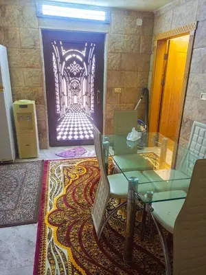 a glass table and chairs in a room with a gate at الاردن جرش سوف in Jerash