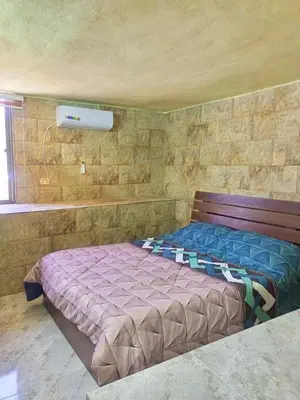 a bedroom with a bed in a brick wall at الاردن جرش سوف in Jerash