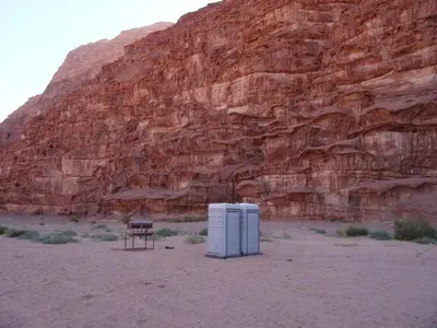 two refrigerators in the desert next to a mountain at Hillawi Private Bedouin Camp in Wadi Rum