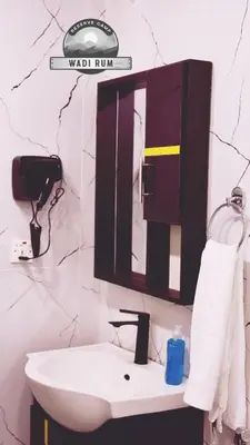 a bathroom with a sink and a mirror at WADI RUM RESERVE BUBBlE CAMP in Wadi Rum