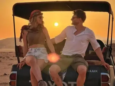 a man and a woman sitting in the back of a golf cart at Ram Camp Desert in Wadi Rum