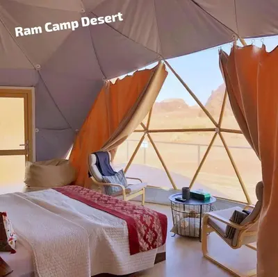 a bedroom with a tent with a view of the desert at Ram Camp Desert in Wadi Rum