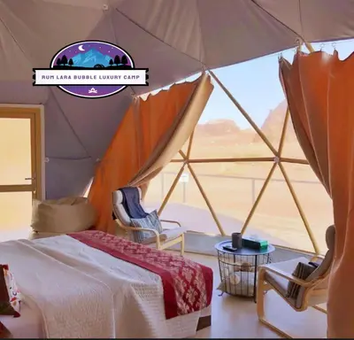a bedroom with a tent with a view of the desert at RUM LARA BUBBLES lUXURY CAMP in Wadi Rum
