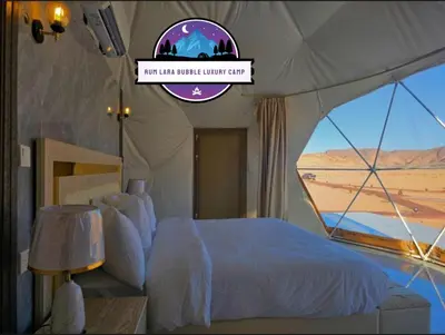 a bedroom with a bed in a tent with a window at RUM LARA BUBBLES lUXURY CAMP in Wadi Rum