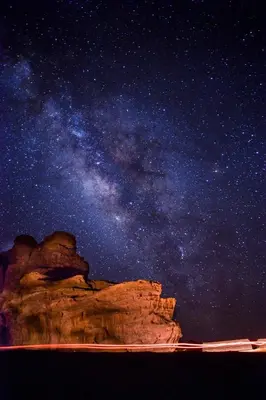 a starry night with the milky way over a cliff at RUM LARA BUBBLES lUXURY CAMP in Wadi Rum