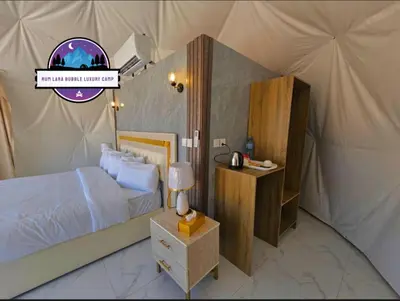 a bedroom with a bed in a tent at RUM LARA BUBBLES lUXURY CAMP in Wadi Rum