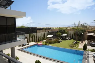 a swimming pool in the backyard of a house at Atlantis The Palm Villa in Al Rama