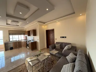 a living room with a couch and a table at شقة للإيجار في عجلون in Ajloun