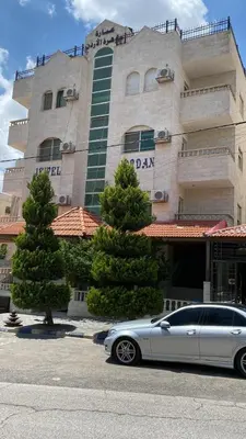 a silver car parked in front of a building at jawharet el ordon in Amman
