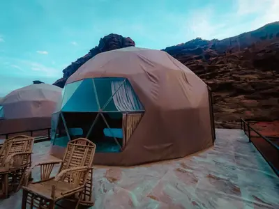 a large dome tent with chairs on top of a mountain at Solar Soul Camp - Wadi Rum Desert Experience & Stargazing in Wadi Rum