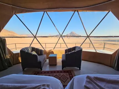 a room with two chairs and a large window at LONAR LORE lUXURY CAMP in Disah