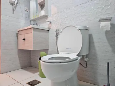a bathroom with a toilet with the lid up at LONAR LORE lUXURY CAMP in Disah