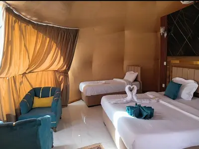 a hotel room with two beds and a chair at LONAR LORE lUXURY CAMP in Disah